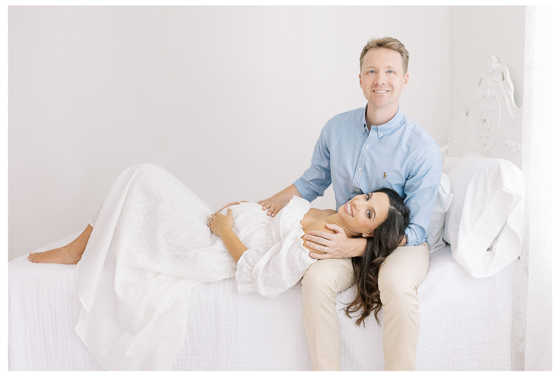 Winter Freire Photography | Natural Light Studio Maternity Session in Dayton, OH | Mama-to-be and husband smiling together with their hands on the baby bump