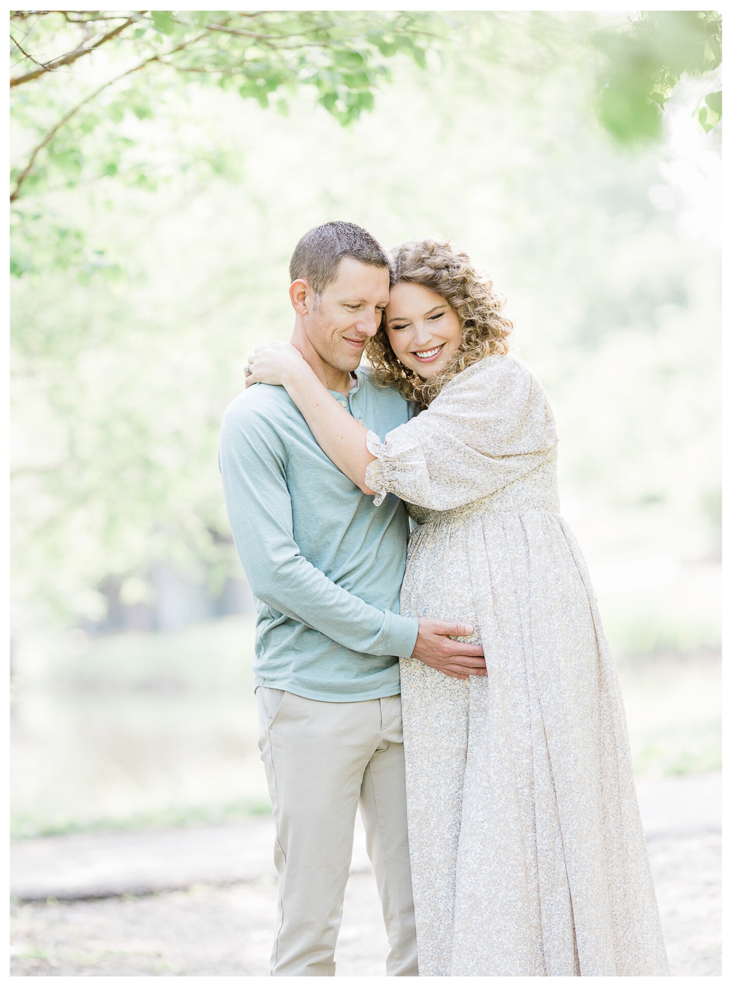 Winter Freire Photography | maternity session outdoors | wife smiing at camera while husband closes his eyes and hugs her