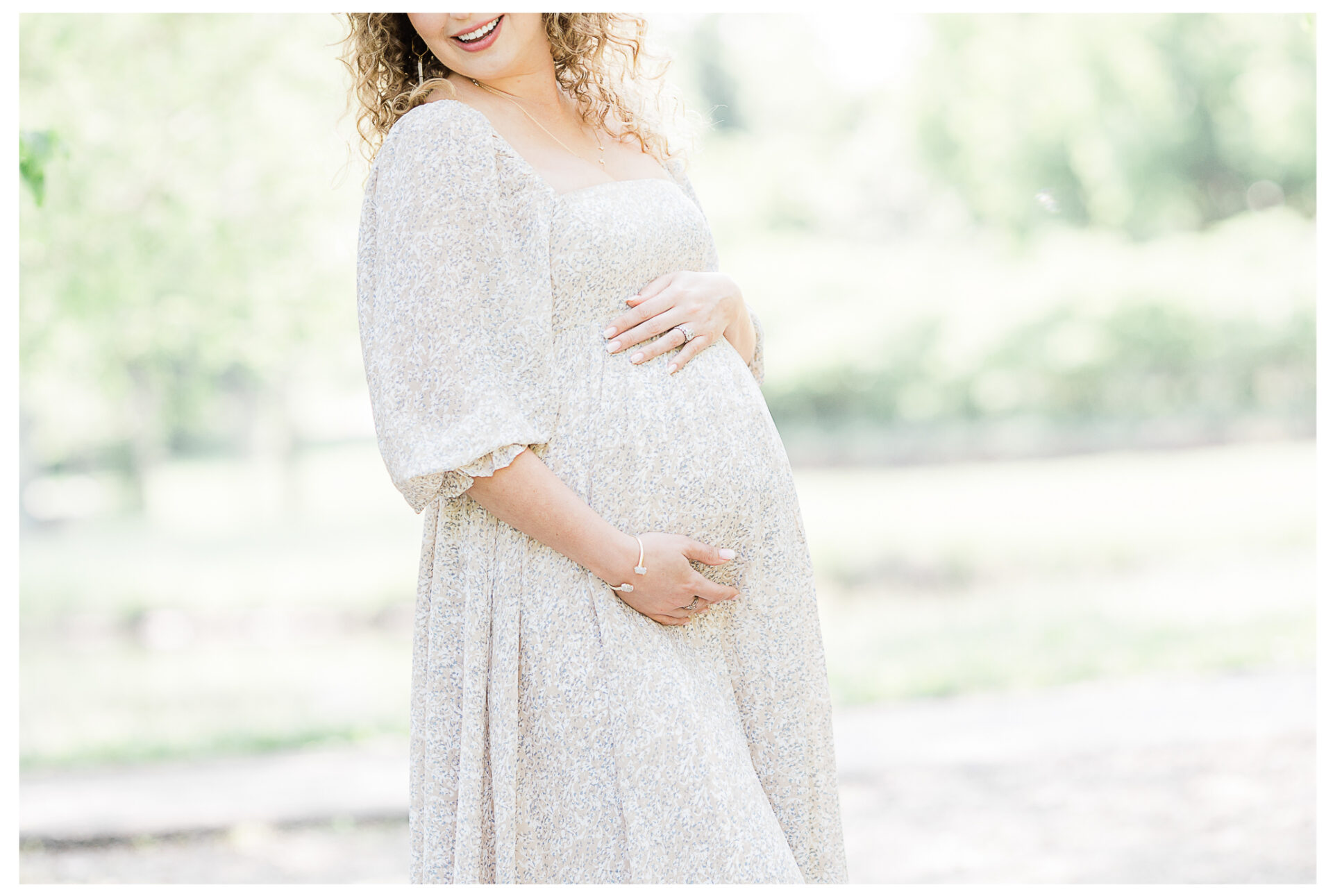 Winter Freire Photography | maternity session outdoors | woman smiling holding her baby bump