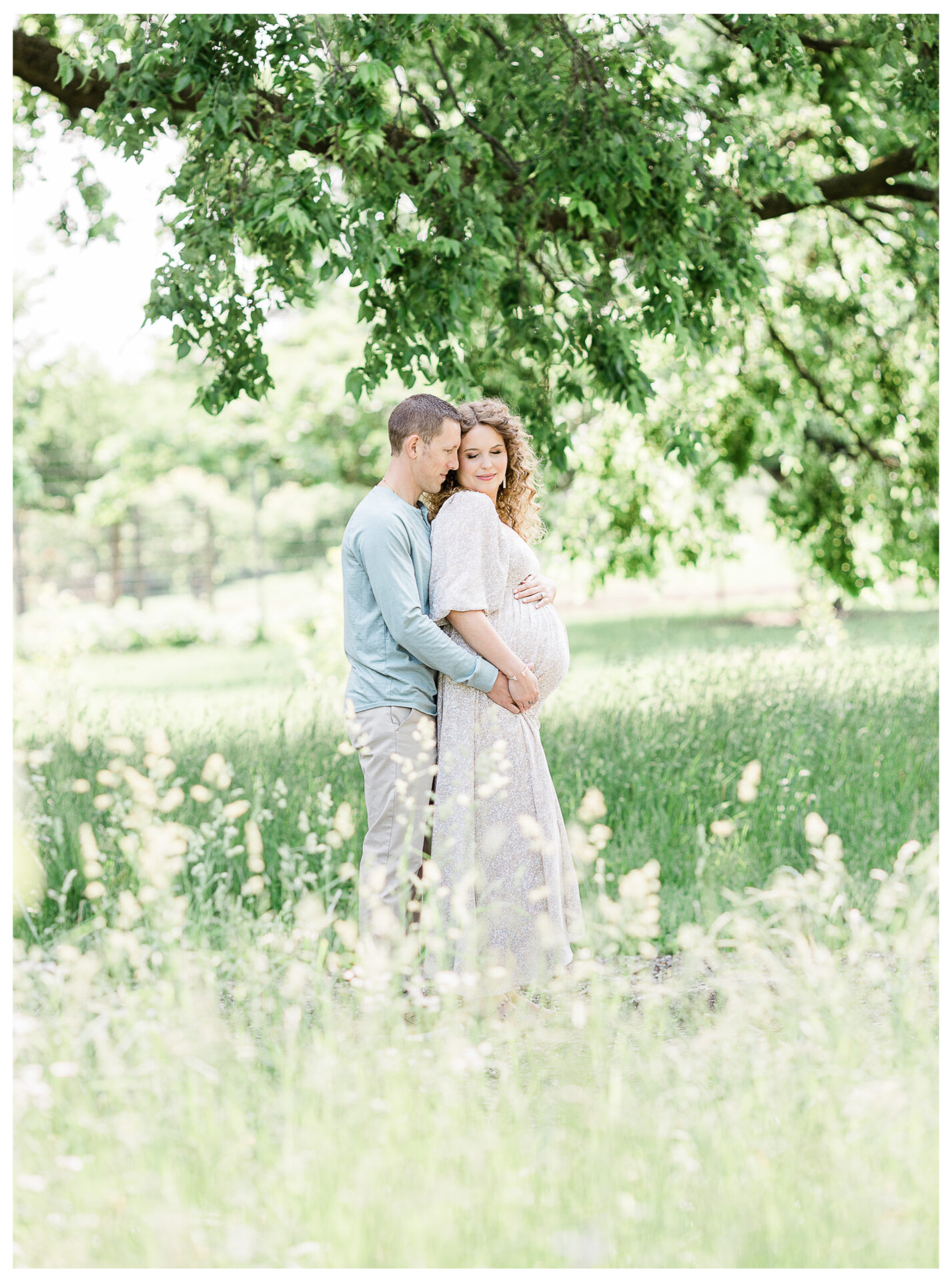 Winter Freire Photography | husband and wife smiling and holding hands in a field of flowers