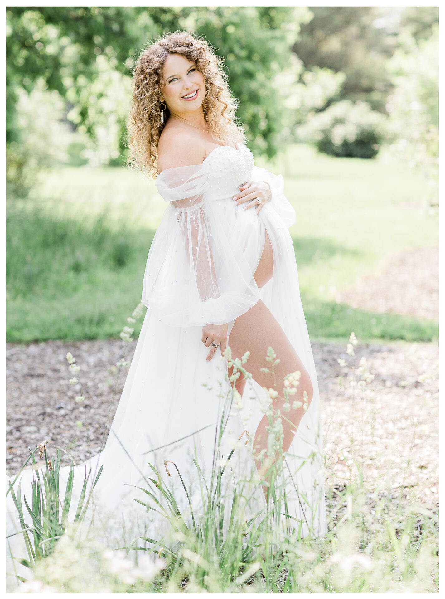 Winter Freire Photography | woman wearing a beautiful white gown during her outdoor summertime maternity session