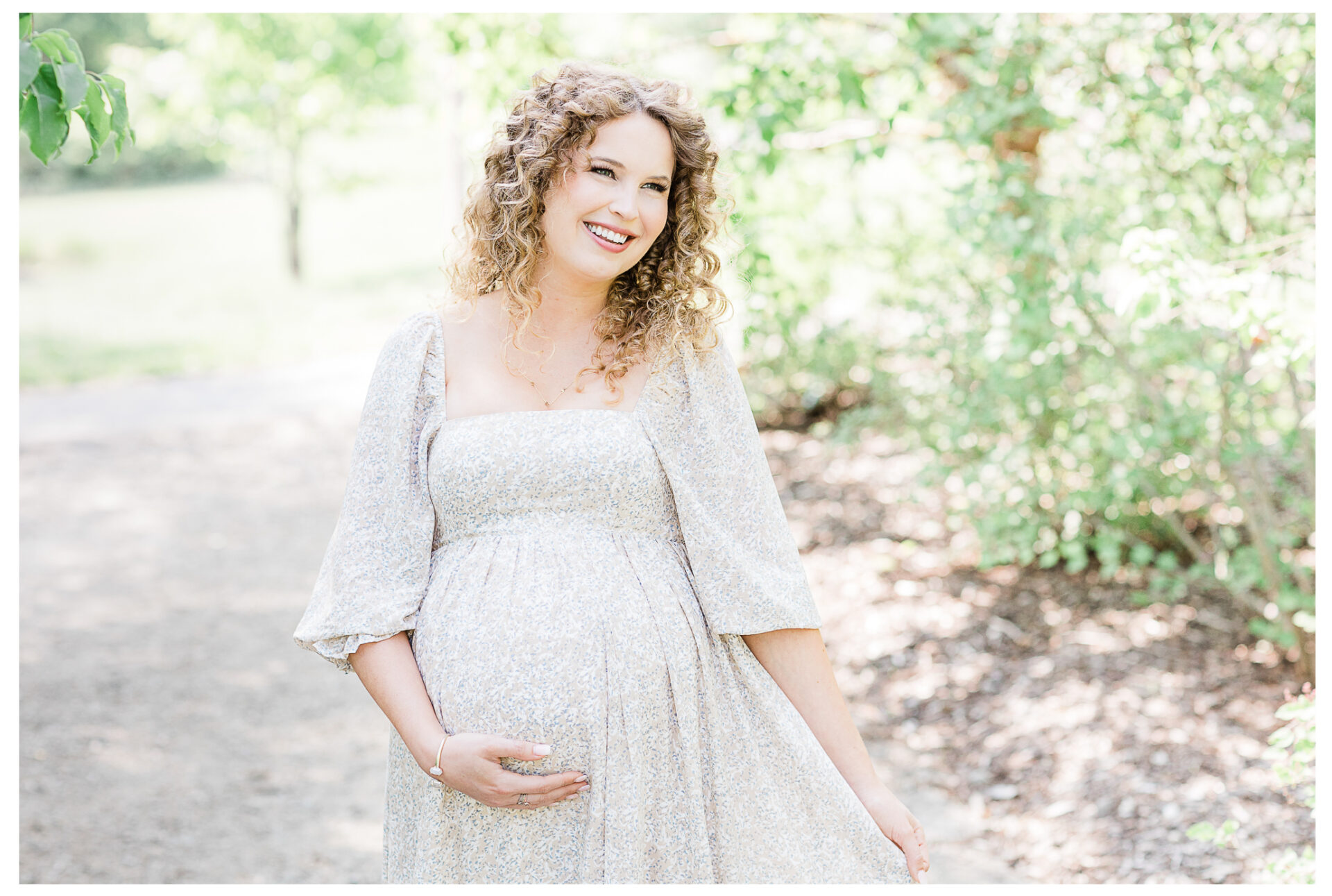 Winter Freire Photography | maternity session outdoors | woman smiling holding her baby bump