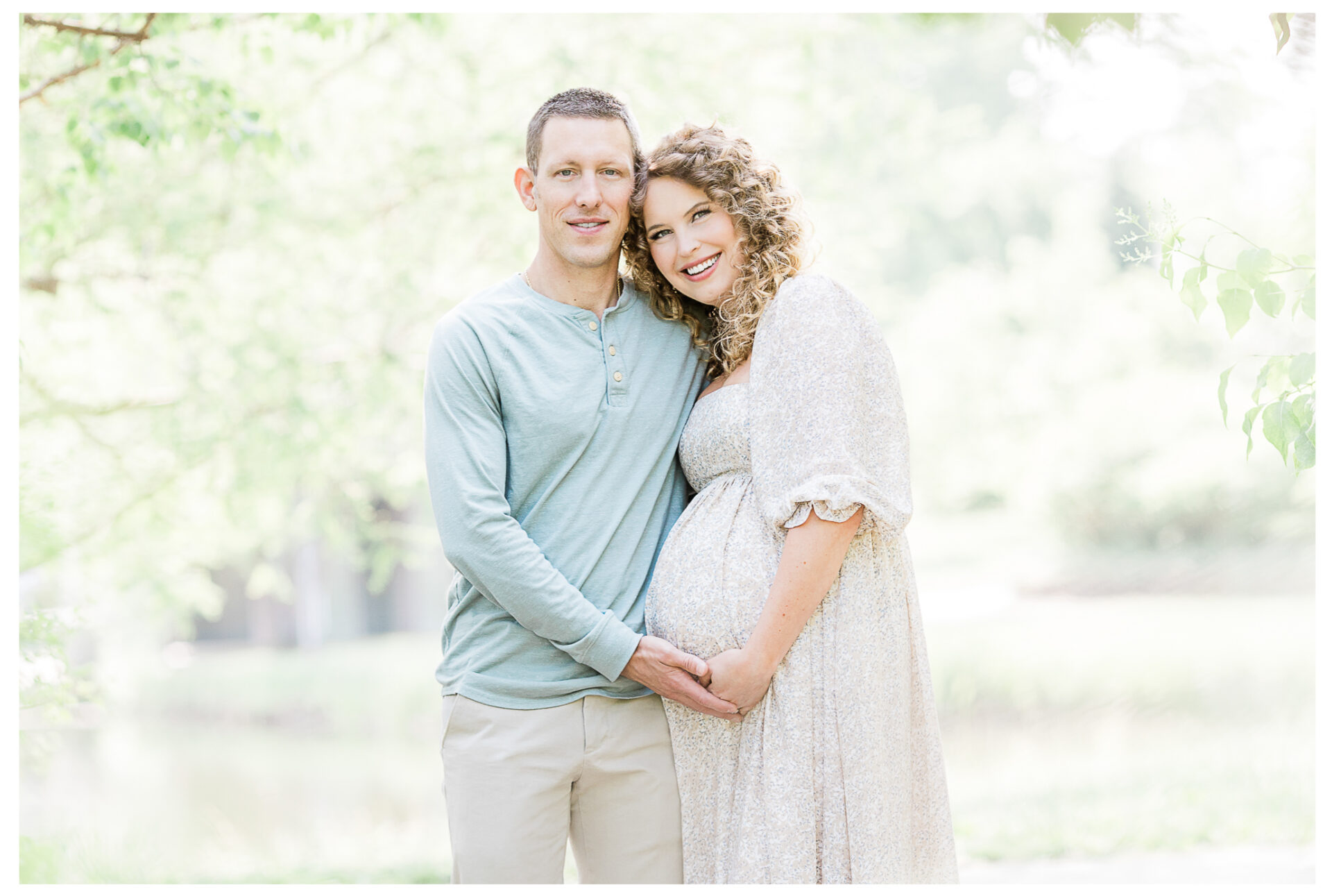 Winter Freire Photography | maternity session outdoors | husband and wife smiling together while placing their hands on the baby bump