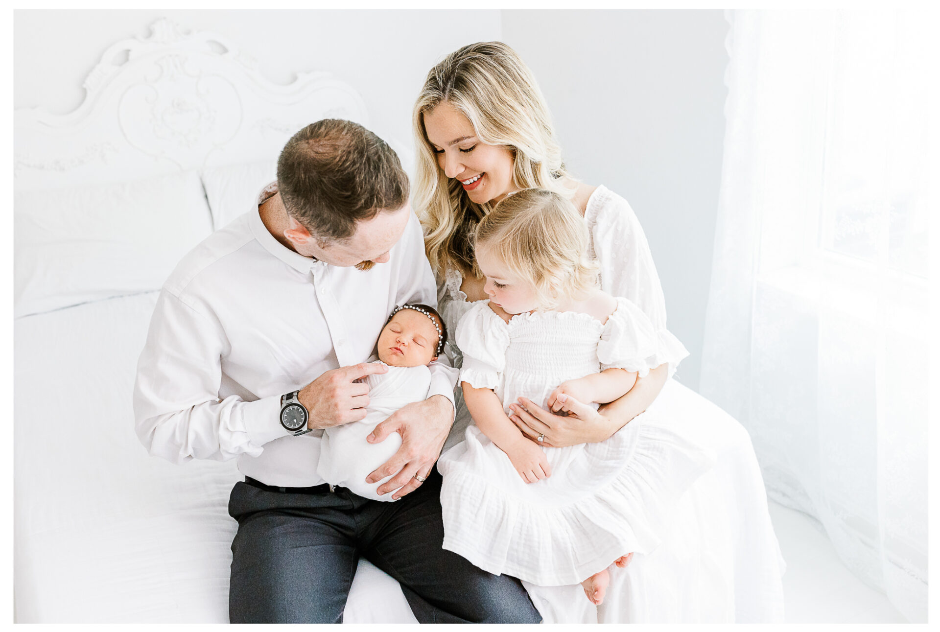 Winter Freire Photography | Dayton, Ohio Newborn Session | Parents sitting together holding newborn baby and older sister