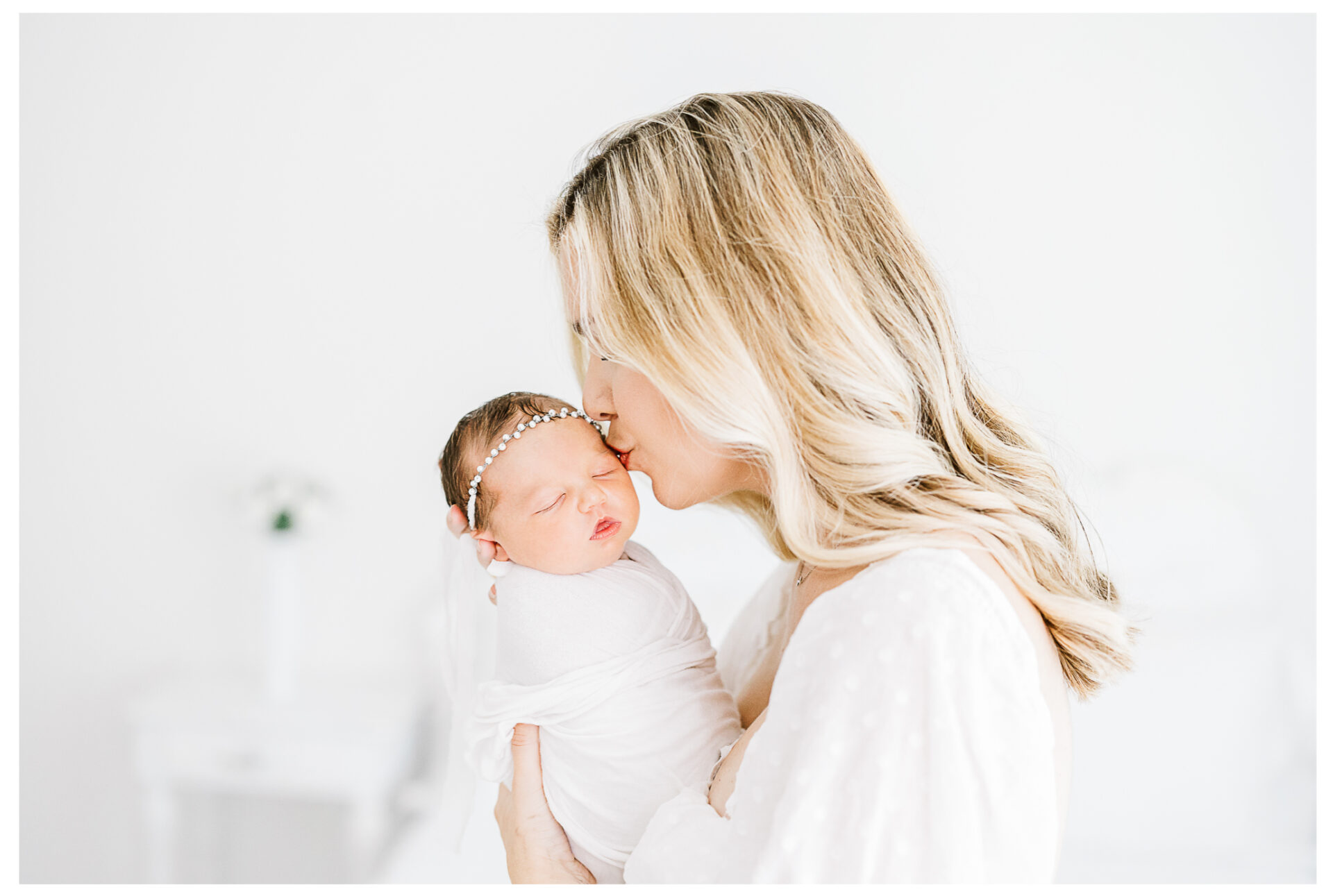 Winter Freire Photography | Dayton, Ohio Newborn Session | Mom standing while kissing her newborn baby girl