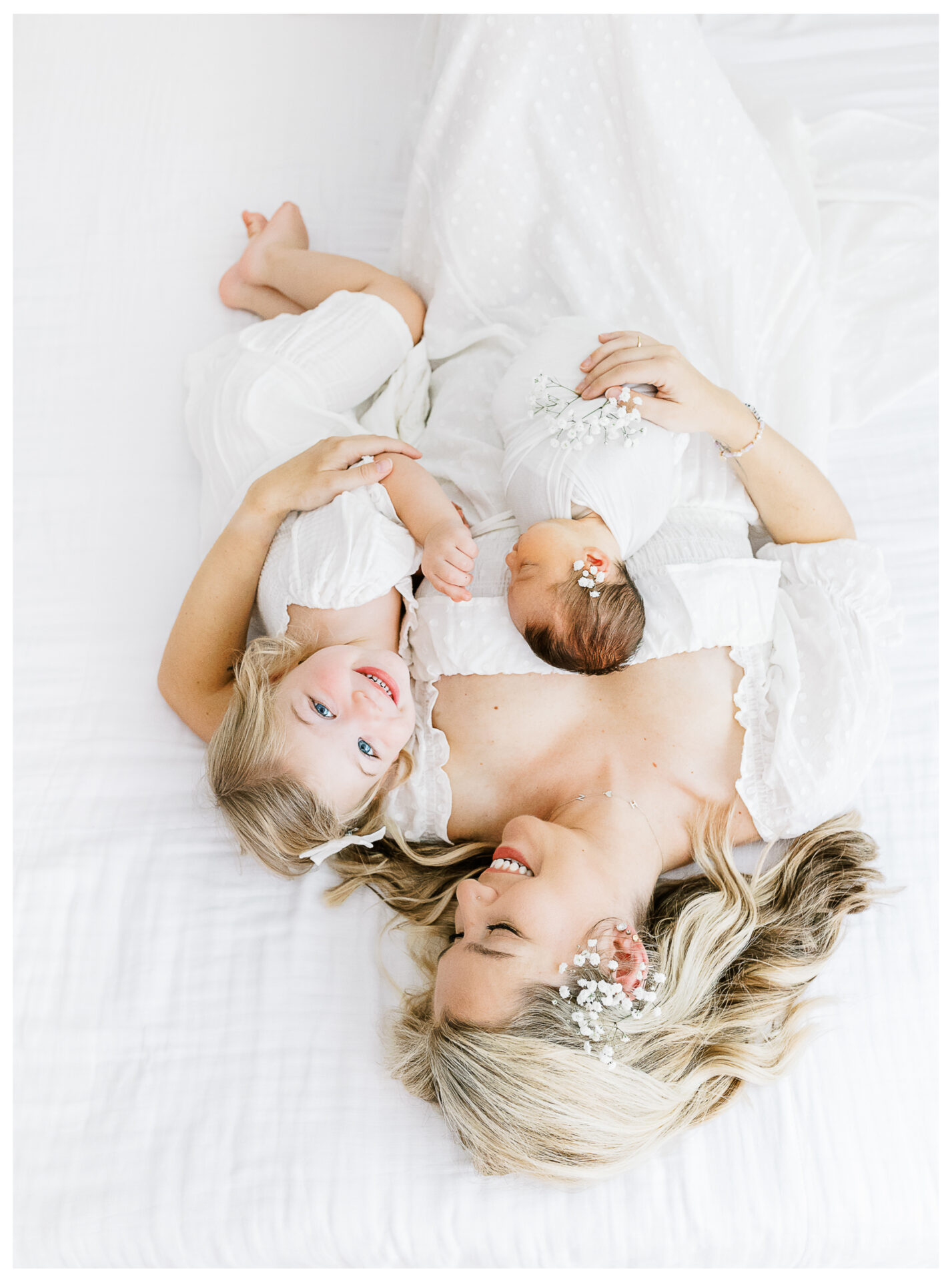 Winter Freire Photography | Dayton, Ohio Newborn Session | Mom laying beside her toddler daughter and newborn baby girl
