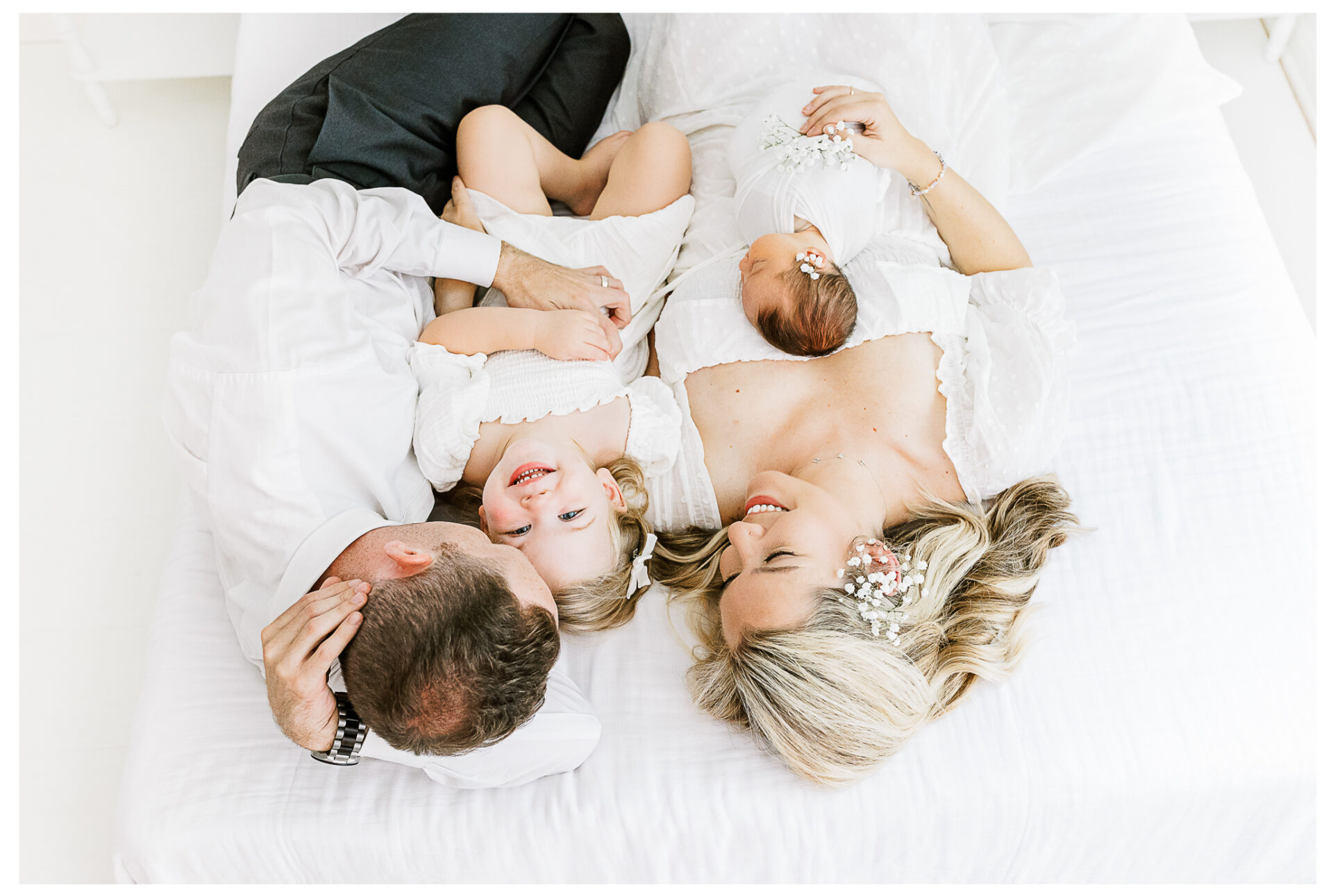 Winter Freire Photography | Dayton, Ohio Newborn Session | Family snuggling together on a bed