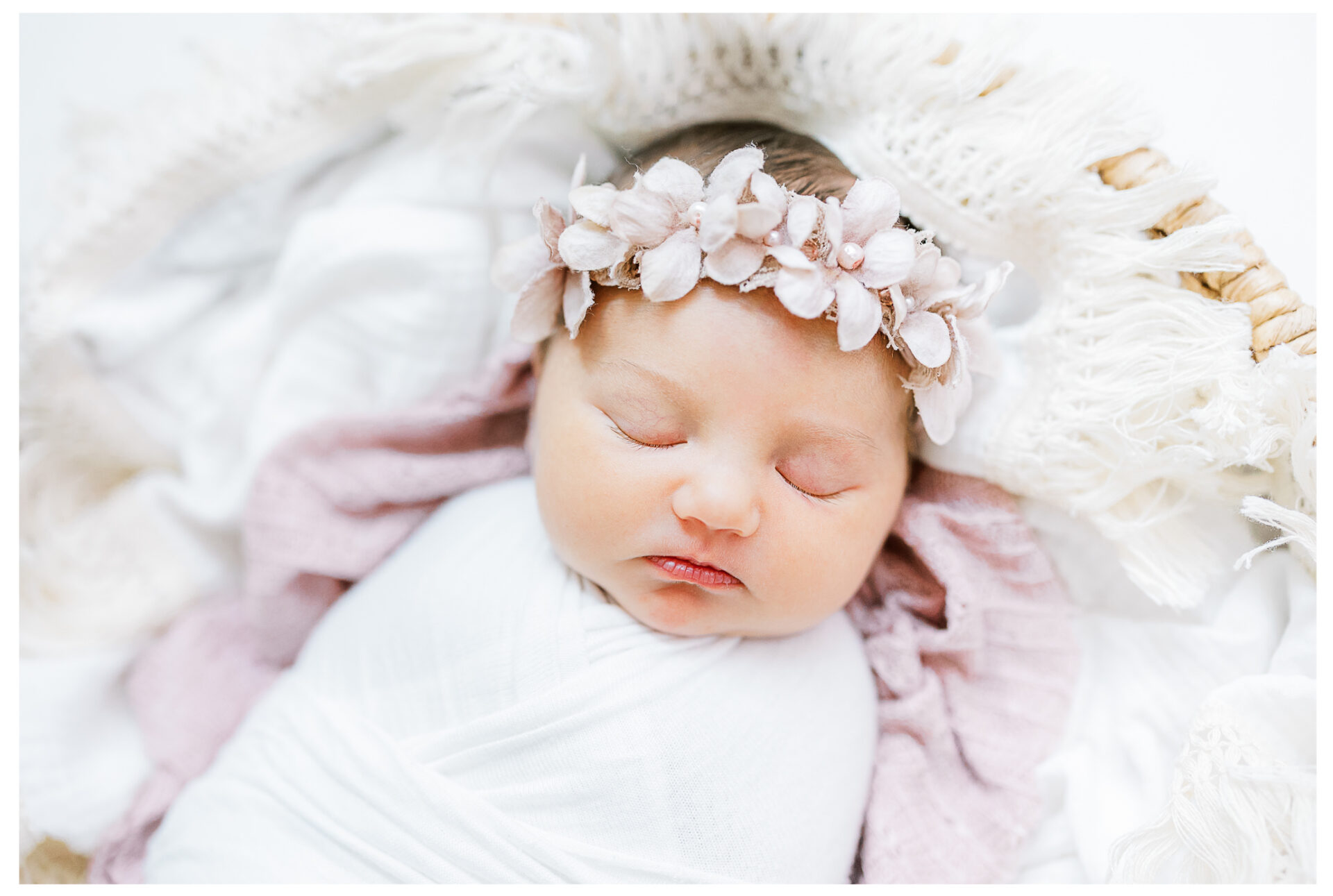 Winter Freire Photography | Dayton, Ohio Newborn Session | Newborn baby girl portraits laying in a basket asleep while wearing a floral headband