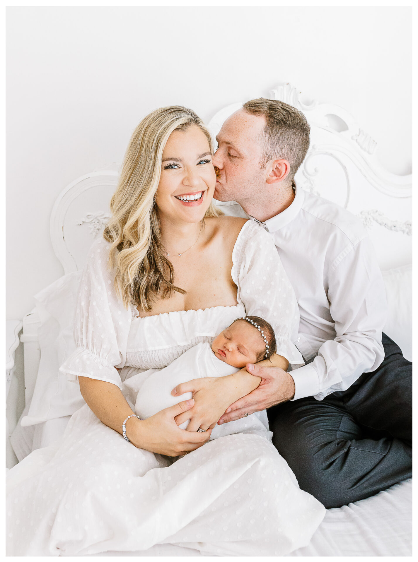 Winter Freire Photography | Dayton, Ohio Newborn Session | Parents holding newborn while husband kisses wife's cheek