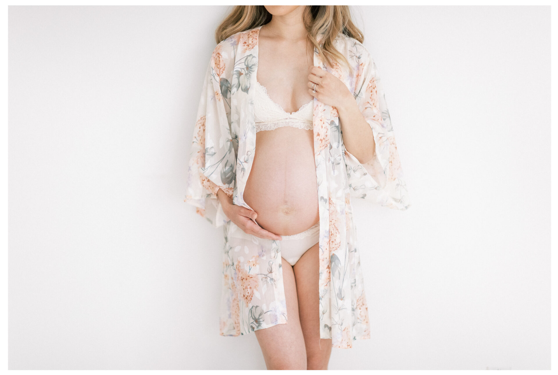Winter Freire Photography | Fine Art Maternity Boudoir | Expecting mother standing while wearing a floral robe
