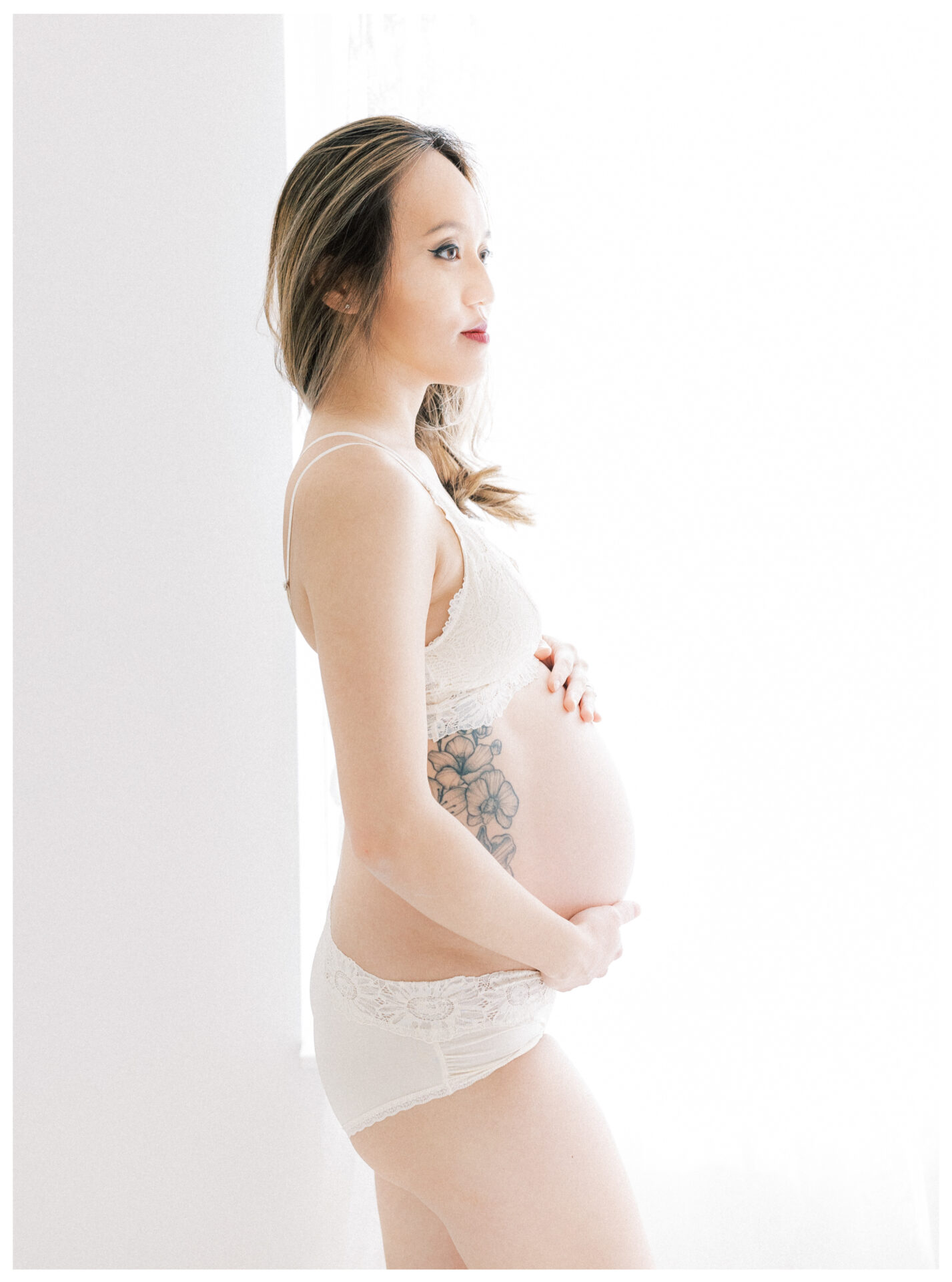 Winter Freire Photography | Fine Art Maternity Boudoir | Expecting mother standing in natural window light