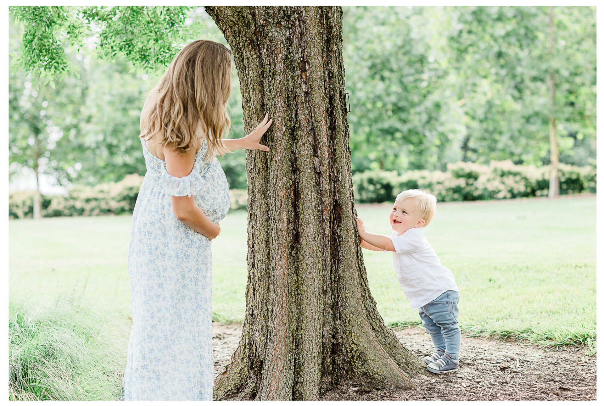 A toddler son smiling at his mother as they play peek-a-boo